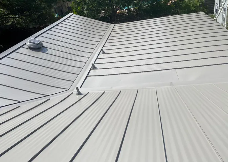 Solar attic fan installed on a metal roof for Roof Ventilation in Cuero